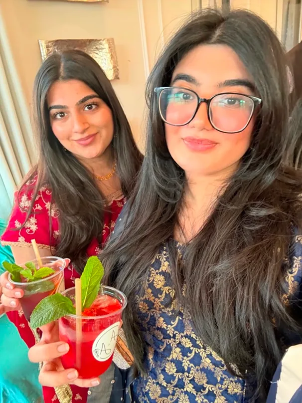 Two guests smiling with their drinks