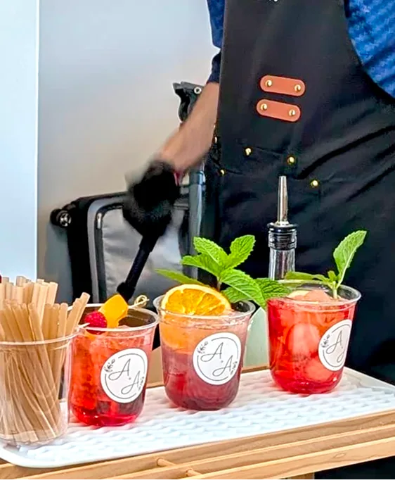 Server finishing drinks at the cart